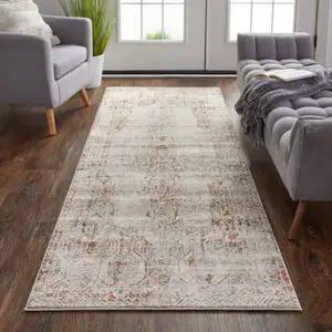 Photo of 10' Ivory Gray and Brown Abstract Power Loom Worn Faded Runner Rug With Fringe