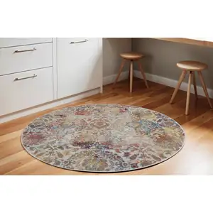 Photo of 6' Ivory Gray and Orange Floral Distressed Non Skid Round Rug