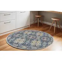 Photo of 6' Ivory Navy Blue and Yellow Floral Distressed Non Skid Round Rug