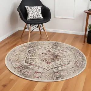 Photo of 6' Ivory Red And Orange Floral Distressed Round Rug