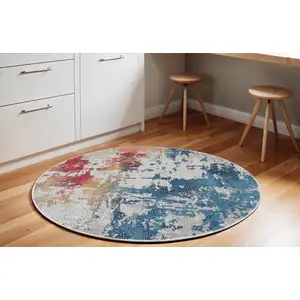 Photo of 6' Ivory Red and Blue Abstract Distressed Non Skid Round Rug