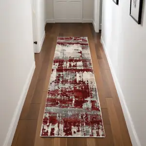 Photo of 8' Ivory Red and Gray Abstract Non Skid Runner Rug