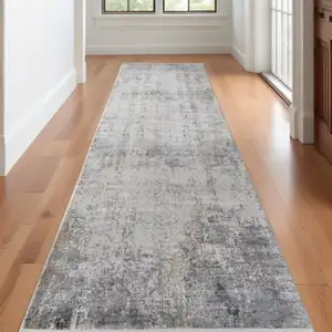 Photo of 10' Ivory Taupe and Gray Abstract Power Loom Distressed Runner Rug With Fringe