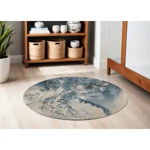 Photo of 4' Ivory Teal Blue and Black Abstract Round Rug