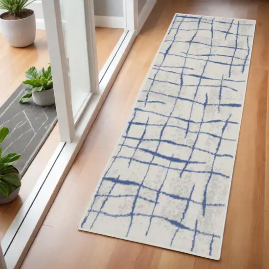 6' Ivory and Blue Abstract Geometric Distressed Runner Rug Photo 1