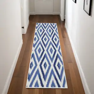 Photo of 8' Ivory and Blue Geometric Distressed Non Skid Runner Rug