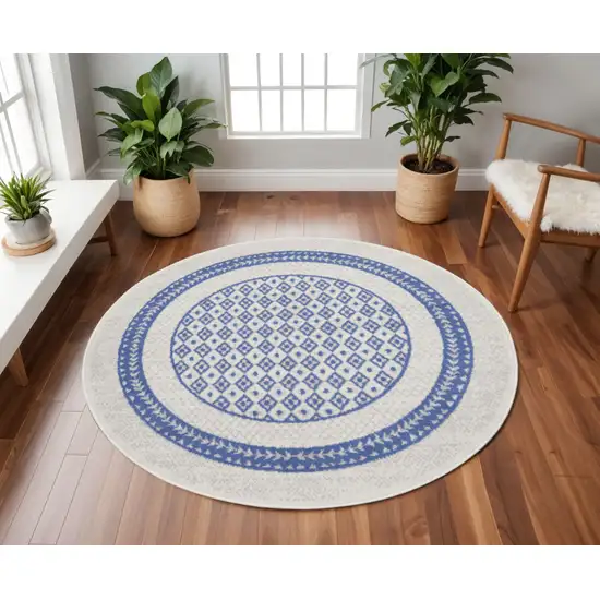 8' Ivory and Blue Geometric Distressed Round Rug Photo 1