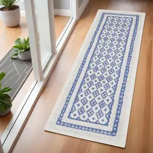 Photo of 6' Ivory and Blue Geometric Distressed Runner Rug