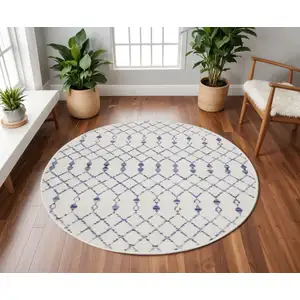 Photo of 8' Ivory and Blue Geometric Round Rug