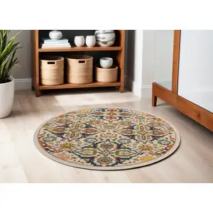 Photo of 5' Ivory and Blue Round Floral Power Loom Area Rug