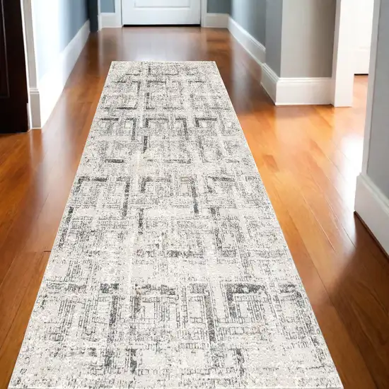 10' Ivory and Gray Geometric Distressed Runner Rug Photo 1