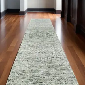 Photo of 10' Ivory and Green Wool Hand Knotted Runner Rug With Fringe