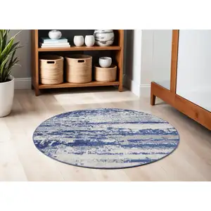 Photo of 5' Ivory and Navy Blue Abstract Round Rug