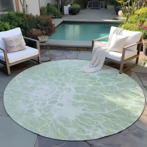 Photo of 8' Mint Green And Ivory Round Abstract Washable Indoor Outdoor Area Rug