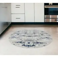 Photo of 4' Navy Blue Round Abstract Washable Non Skid Area Rug With Fringe