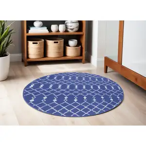 Photo of 5' Navy Blue and Ivory Geometric Round Rug