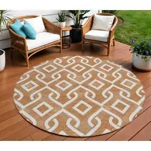 Photo of 8' Orange And Ivory Round Geometric Washable Indoor Outdoor Area Rug