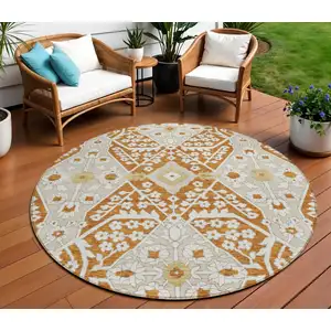 Photo of 8' Orange Beige And Gold Round Floral Washable Indoor Outdoor Area Rug