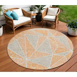 Photo of 8' Orange Gray And Silver Round Geometric Washable Indoor Outdoor Area Rug