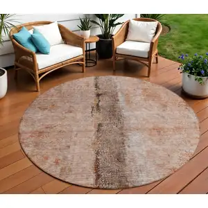 Photo of 8' Orange Peach And Brown Round Abstract Washable Indoor Outdoor Area Rug