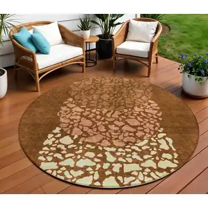 Photo of 8' Orange Terra Cotta And Ivory Round Abstract Washable Indoor Outdoor Area Rug