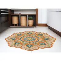 Photo of 6' Orange and Blue Round Wool Floral Hand Tufted Area Rug