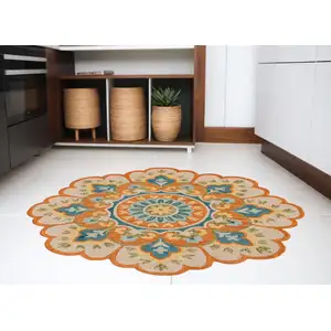 Photo of 6' Orange and Blue Round Wool Floral Hand Tufted Area Rug