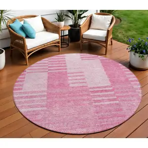 Photo of 8' Pink And Blush Round Striped Washable Indoor Outdoor Area Rug