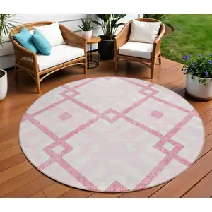 Photo of 8' Pink Blush And Ivory Round Geometric Washable Indoor Outdoor Area Rug