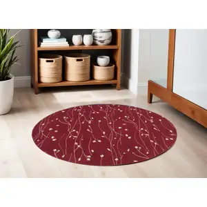 Photo of 4' Red Black and Ivory Round Floral Vines Power Loom Area Rug