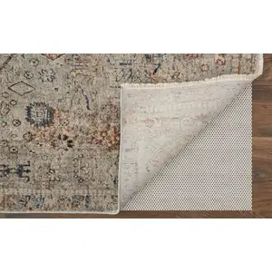 Photo of 10' Red Tan and Blue Oriental Power Loom Worn Faded Runner Rug With Fringe