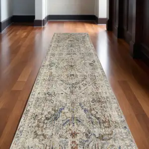 Photo of 12' Red Tan and Blue Oriental Power Loom Worn Faded Runner Rug With Fringe