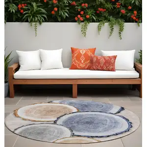 Photo of 8' Round Beige Blue and Gold Round Faux Bois Washable Non Skid Indoor Outdoor Area Rug