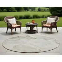 Photo of 8' Round Beige and Ivory Round Abstract Washable Non Skid Indoor Outdoor Area Rug