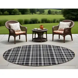 Photo of 8' Round Black Gray and White Round Plaid Washable Non Skid Indoor Outdoor Area Rug