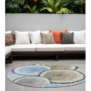 Photo of 8' Round Blue Gold and Gray Round Faux Bois Washable Non Skid Indoor Outdoor Area Rug