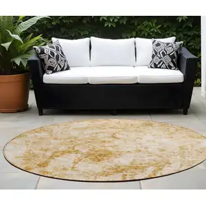 Photo of 8' Round Cream and Gold Round Abstract Washable Non Skid Indoor Outdoor Area Rug