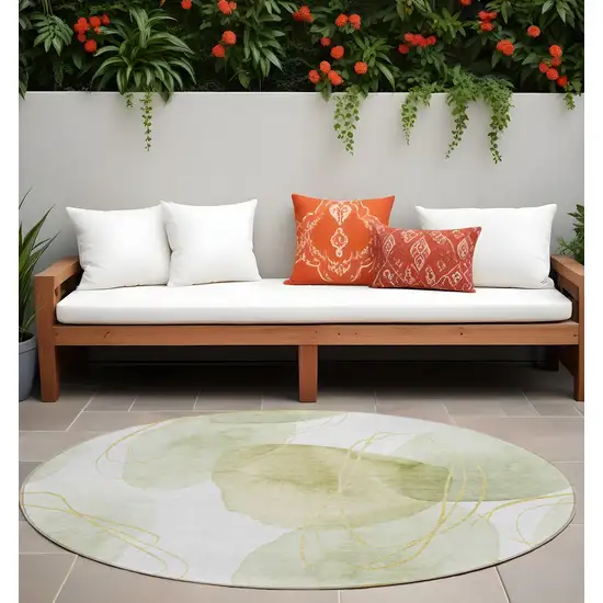 Green and Ivory Round Abstract Washable Non Skid Indoor Outdoor Area Rug Photo 1