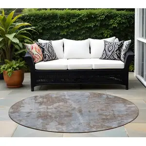 Photo of 8' Round Mocha and Blue Round Abstract Washable Non Skid Indoor Outdoor Area Rug