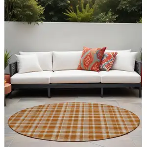 Photo of 8' Round Orange and Ivory Round Plaid Washable Non Skid Indoor Outdoor Area Rug