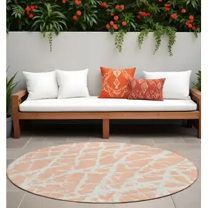 Photo of 8' Round Peach and Ivory Round Abstract Washable Non Skid Indoor Outdoor Area Rug