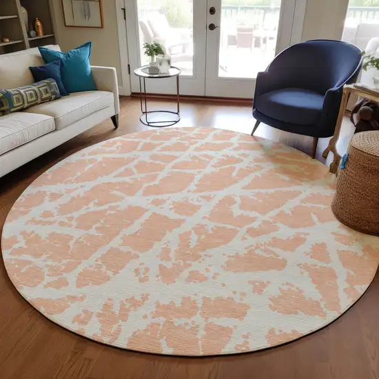 8' Round Peach and Ivory Round Abstract Washable Non Skid Indoor Outdoor Area Rug Photo 9