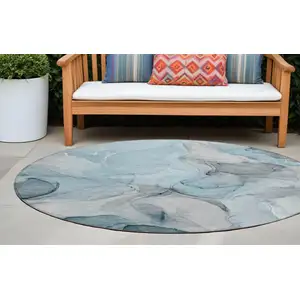 Photo of 8' Round Teal Round Abstract Washable Non Skid Indoor Outdoor Area Rug