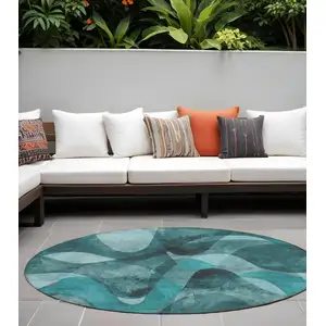 Photo of 8' Round Teal Round Abstract Washable Non Skid Indoor Outdoor Area Rug