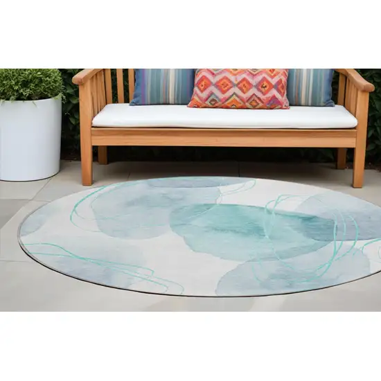 Teal and Ivory Round Abstract Washable Non Skid Indoor Outdoor Area Rug Photo 1