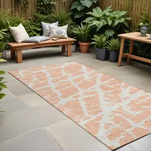 Photo of 8' Runner Peach and Ivory Abstract Washable Non Skid Indoor Outdoor Runner Rug