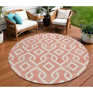 Photo of 8' Salmon And Ivory Round Geometric Washable Indoor Outdoor Area Rug