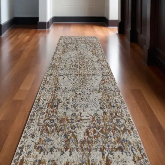 12' Tan Blue and Brown Oriental Power Loom Worn Faded Runner Rug With Fringe Photo 1