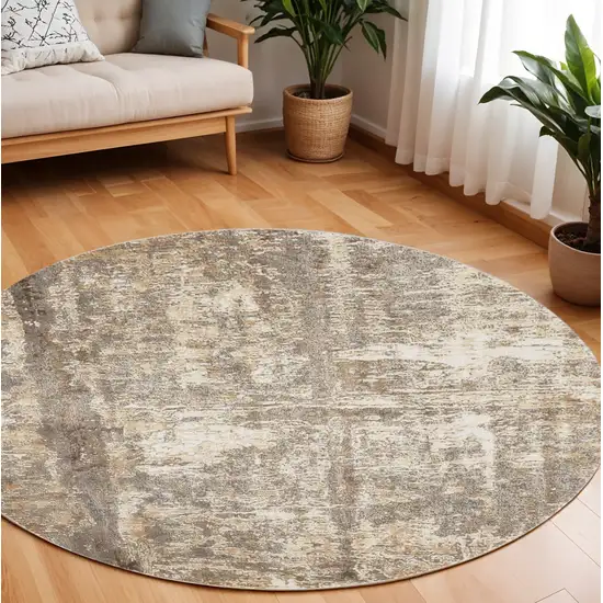 8' Tan and Ivory Abstract Non Skid Round Rug Photo 1