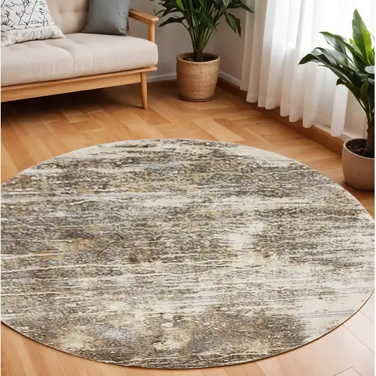 8' Tan and Ivory Abstract Non Skid Round Rug Photo 1